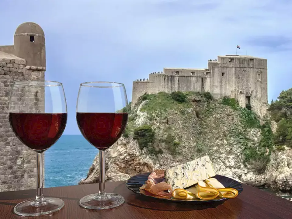 Two glasses of wine with view of Fortress Lovrijenac from Dubrovnik city walls