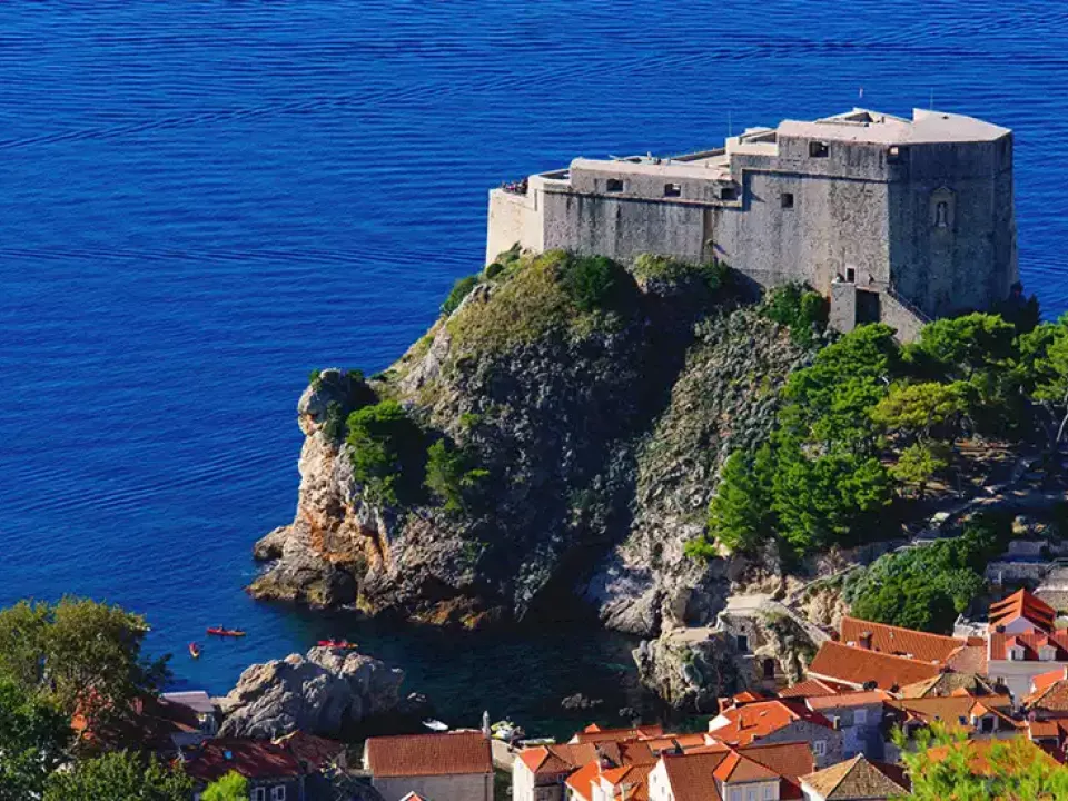 Two glasses of wine with view of Fortress Lovrijenac from Dubrovnik city walls