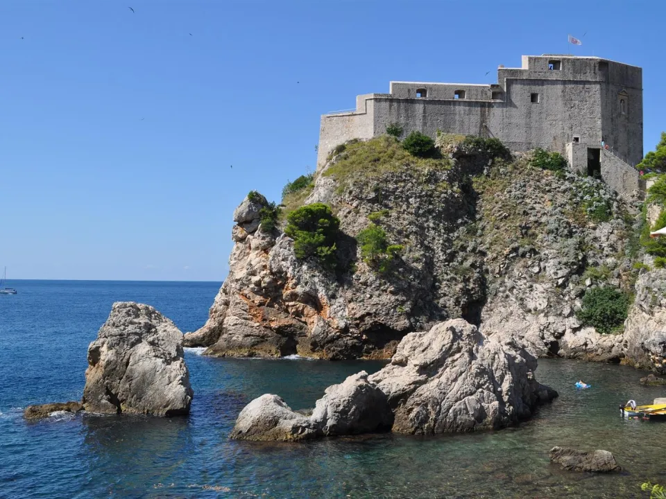Two glasses of wine with view of Fortress Lovrijenac from Dubrovnik city walls