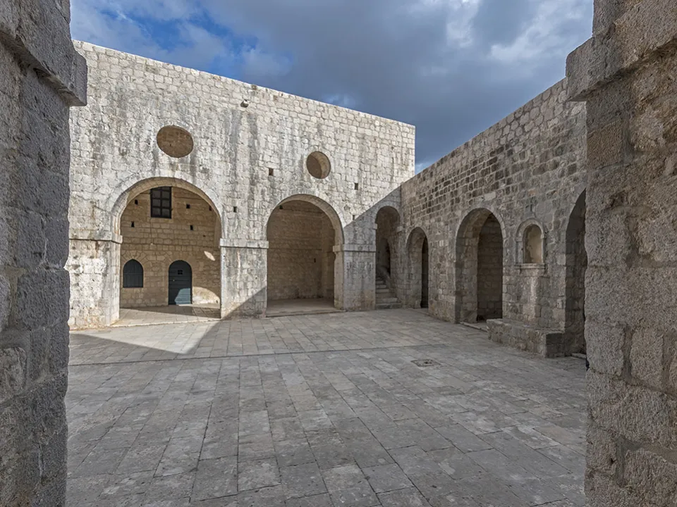 Two glasses of wine with view of Fortress Lovrijenac from Dubrovnik city walls