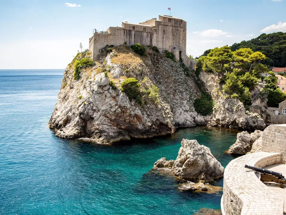 Two glasses of wine with view of Fortress Lovrijenac from Dubrovnik city walls